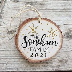 a wooden ornament that says the sonksen family on it with snowflakes