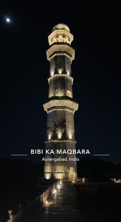 a tall tower lit up at night with the words bibi ka maagara