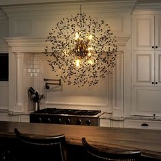 a chandelier hanging from the ceiling in a kitchen