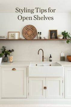 a kitchen with white cabinets and open shelving above the sink is featured in an article about styling tips for open shelves