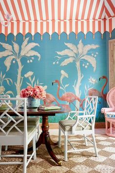 a dining room with flamingos painted on the wall