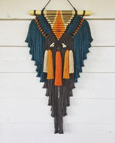 a wall hanging with fringes and tassels on it