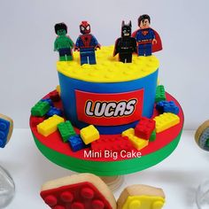 a birthday cake with legos on the top and other toys around it that are also made out of legos