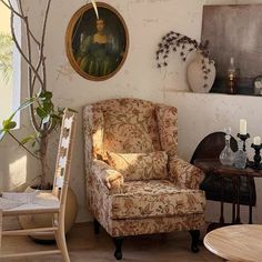 a living room filled with furniture and a painting on the wall above it's head