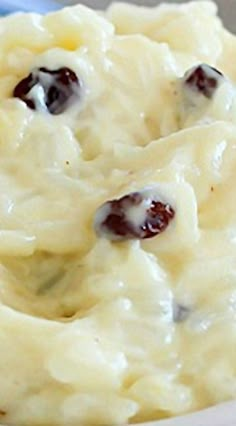 a bowl filled with mashed potatoes covered in raisins