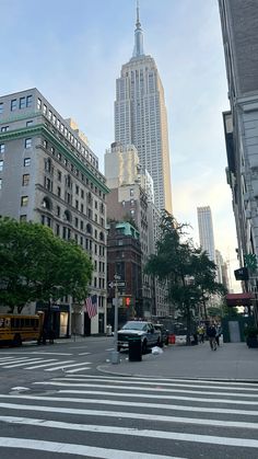 a city street with tall buildings in the background