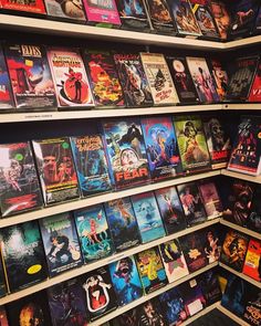 there are many movie posters on the shelves