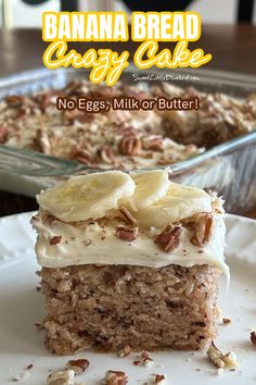 a banana bread cake with cream cheese frosting and sliced bananas on top, sitting on a white plate