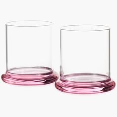 two pink glass vases sitting next to each other