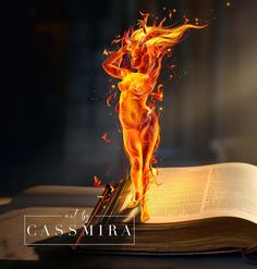 an open book with a fire figure on top of it