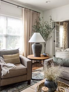 a living room filled with furniture and a lamp