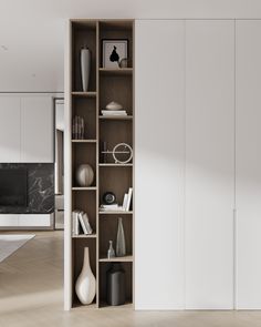 an open bookcase in the middle of a room with white walls and wooden floors