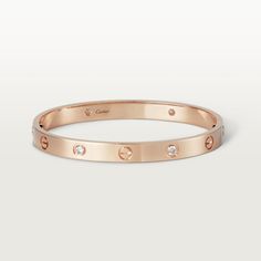 Cartier - LOVE bracelet, 4 diamonds - Bracelet Gold - LOVE bracelet, 18K rose gold (750/1000), set with 4 brilliant-cut diamonds totaling 0.42 carats. Comes with a screwdriver. Width: 6.1 mm. Created in New York in 1969, the LOVE bracelet is an icon of jewelry design: a close fitting, oval bracelet composed of two rigid arcs which is worn on the wrist and removed using a specific screwdriver. The closure is designed with two functional screws placed on either side of the bracelet: you will need Quotes For Wife, The Bling Ring, Wife And Husband, Birthday Sister, Cartier Bracelet, Wrist Jewelry, Luxury Bracelet, Luxe Jewelry, Bracelet Love