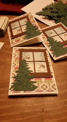 four cards with trees on them sitting on a table