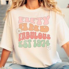 This custom retro, fifty and fabulous shirt is perfect for a 50th birthday or to gift to someone turning 50. Customize the birth year for a special and personal touch.  Sizing - This shirt is a relaxed unisex fit- please refer to photo above for sizing reference.  Shipping - This item is shipped within 2-5 business days. Please reach out if you have any issues with your order.  Feedback- Don't be shy I welcome and encourage all feedback. Thank you :) Retro White Top For Birthday, Retro White Tops For Anniversary, Retro Summer Tops For Anniversary, Fifty Birthday Shirts For Family, Retro White T-shirt For Birthday, 50th Birthday Tshirts For Family, Happy 50th Birthday Tshirts Design, Fifty Licious T Shirt, Vintage T-shirt With Funny Print For Birthday