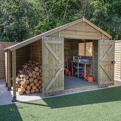 a wooden shed with doors open on the side and logs stacked in front of it