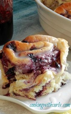 a piece of pie sitting on top of a white plate next to a bowl of fruit