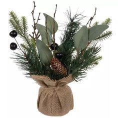 a vase filled with lots of green leaves and pine cones on top of a burlock