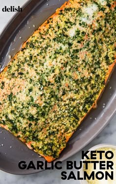 a pan filled with cooked fish next to a bowl of seasoning and spoons