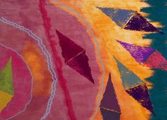 a colorful rug with different colored shapes and colors on it's surface, including an abstract design