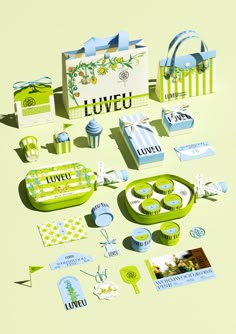 an assortment of green and blue items on a yellow tablecloth with the words loveu written in white