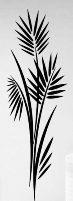 a black and white photo of a palm tree wall decal in a kitchen area