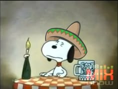 a cartoon dog wearing a sombrero sitting on top of a checkered table