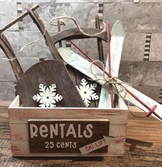 a wooden box filled with skis on top of a table