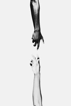 two hands reaching up to each other in the air, with one hand holding another