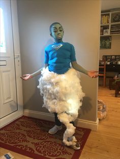 a woman is dressed up in a costume made out of white yarn and cotton balls