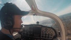 a man flying in the air while wearing a helmet and holding a remote control device