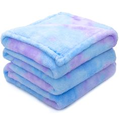 four blue and purple towels stacked on top of each other