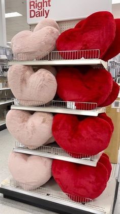 several heart shaped pillows are on display in a grocery store, with the price tag right daily