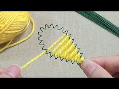 someone is knitting something yellow on the table