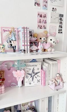 there are many books and stuffed animals on the shelves in this girls's room