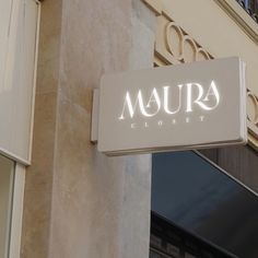 there is a sign that says maura closet on the side of a building in front of a window