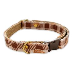 a brown and white dog collar with gold hardware