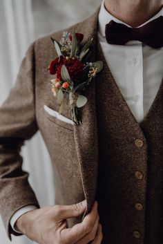 a man wearing a brown suit and bow tie