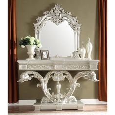 an ornate white console table with mirror and vase