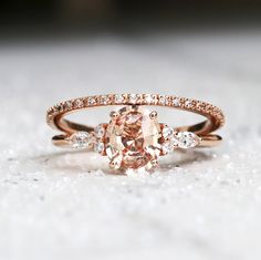 an engagement ring with a fancy peach diamond