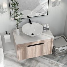 a bathroom with a sink, toilet and mirror on the wall next to a trash can