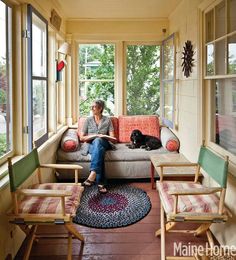 the front cover of maine home and design featuring a woman sitting on a couch with her dog