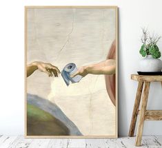 the creation of man's hand is depicted in an art print on a wall