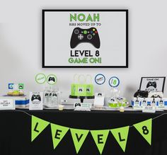 the table is set up with video game controllers and games on it for an event