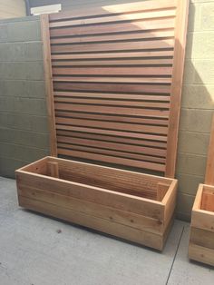 two wooden planters sitting next to each other