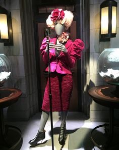 a mannequin dressed in pink and holding a microphone