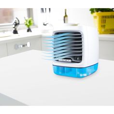 a white and blue air cooler sitting on top of a counter