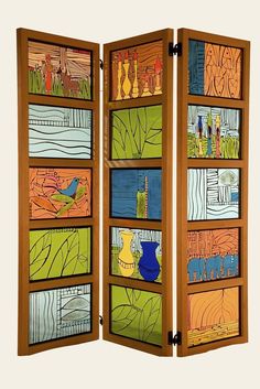 an open wooden screen with colorful paintings on it's sides and two panels showing different scenes