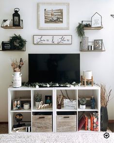 a tv is sitting on top of a white shelf