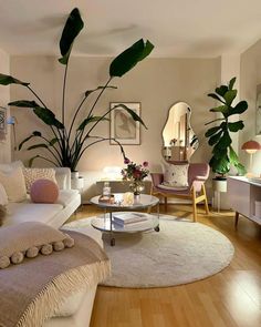 a living room filled with furniture and lots of plants in the middle of the room